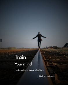 a person walking on train tracks with their arms spread out and the words train your mind to be calm in every situation