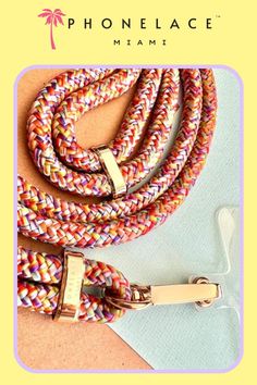 a colorful leash with gold buckles on it and the words phonelace miami written in white