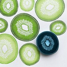 a blue and green object sitting on top of a white table next to some circles