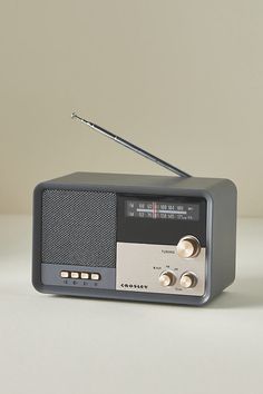 an old fashioned radio sitting on top of a white table next to a black pen