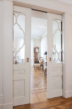 an open door with mirrored glass on the front and side doors, in a living room