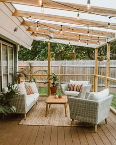 an outdoor living area with couches, chairs and a coffee table on the deck