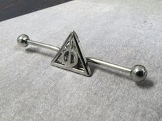 a pair of stainless steel balls and triangle shaped barbells