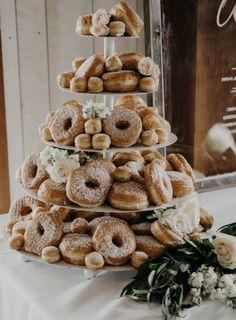 a large stack of donuts sitting on top of a table