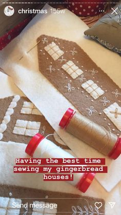 some christmas decorations are on the table and there is a message written in red that says, having the best time sewing my gingerbread houses