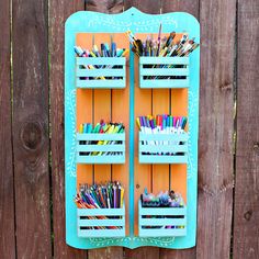 a wooden fence with a blue shelf filled with pencils