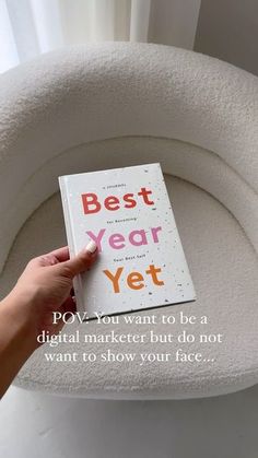 a person is holding up a book about the best year yet