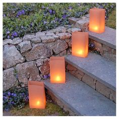 three lit candles sitting on some steps