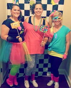 three women dressed up in costumes posing for the camera