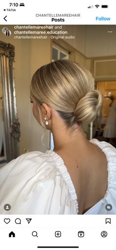 a woman with blonde hair is looking at herself in the mirror and wearing a white dress