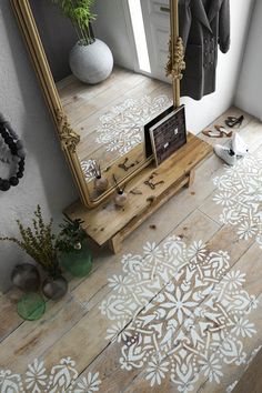 the floor is decorated with white stencils and flowers on it, along with a mirror