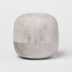 a white cement stool sitting on top of a table