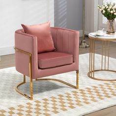 a living room with a pink chair and table