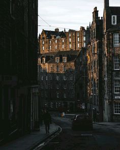 an old city street with tall buildings on both sides