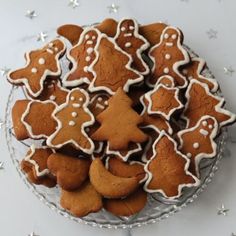 a plate full of ginger cookies with white icing on them and stars in the background