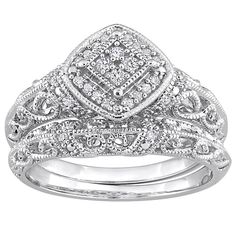 two pieces of white gold wedding ring set with diamonds on the sides and an intricate design