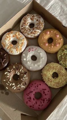 a box filled with lots of different flavored donuts