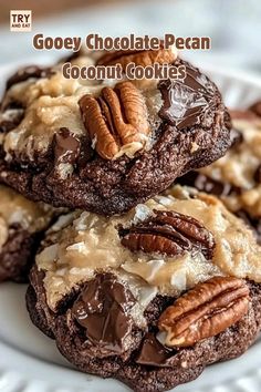 three chocolate pecan cookies on a white plate