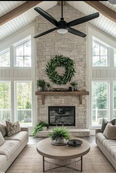 a living room with two couches and a coffee table in front of a fireplace