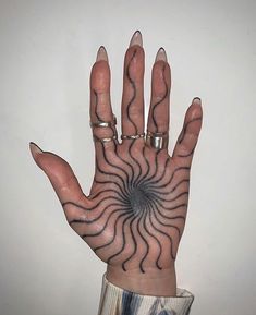 a person's hand with tattoos on it