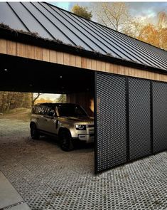 a car is parked in front of a garage door with a metal grid on the side