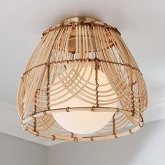 a bamboo light fixture hanging from the ceiling