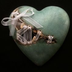 a heart shaped object with ribbons on it