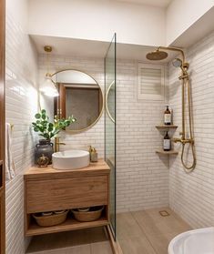 a bathroom with a sink, mirror and shower head in it's corner area