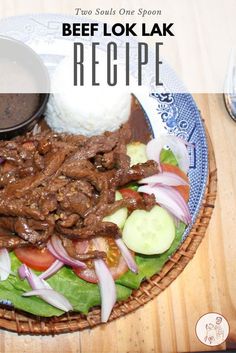 beef lok lak recipe on a plate with rice and vegetables