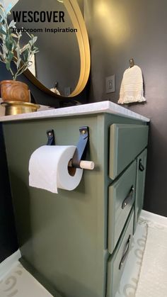 a bathroom with a green cabinet and toilet paper