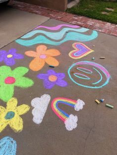 the sidewalk has been decorated with chalk and crayons to spell out letters, numbers, and flowers