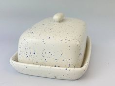 a white dish with blue speckles on it