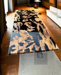 the table is made out of black and gold leafy wood, with a lamp on top