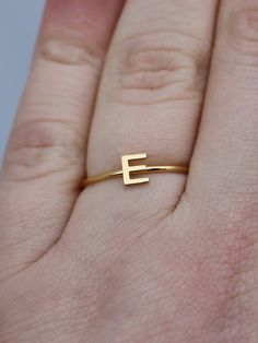 This elegant gold initial ring is perfect for stacking, making it a great gift for any occasion - whether a mother's day surprise or a best friend's birthday present. Crafted from quality stainless steel, this letter ring will look beautiful for years to come. Featuring a letter of your choosing, this ring can be worn alone or stacked making it perfect for gifting to friends or family. The subtle, yet sweet letter ring looks elegant alone or as part of a larger stack. This gold letter ring is th Rose Gold Initial Ring With Simple Design For Anniversary, Everyday Gold Stackable Rings With Initials, Gold Stackable Rings With Initials For Everyday, Minimalist Monogram Initial Ring, Minimalist Initial Rose Gold Ring, Valentine's Day Gift Minimalist Initial Ring, Everyday Open Initial Ring, Everyday Initial Open Ring, Simple Personalized Gold Stackable Rings