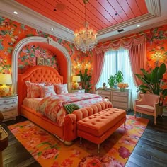 an orange bedroom with floral wallpaper and chandelier above the bed is decorated in pink