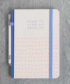 a notepad and pen sitting on top of a notebook with the words plan it, live it, love it