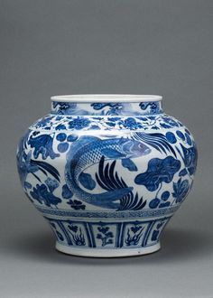 a blue and white vase sitting on top of a table