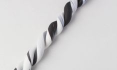 a black and white twisted rope on a white surface