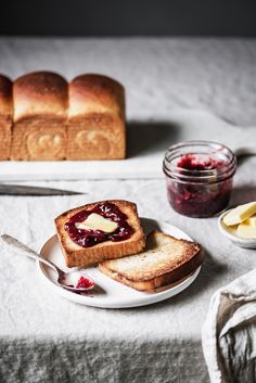 two slices of bread on a plate with jam and butter