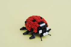 a red and black bug made out of legos