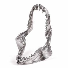 a silver ring that is shaped like a shark's mouth with teeth on it