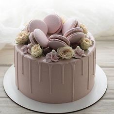 a chocolate cake with macaroons and roses on top