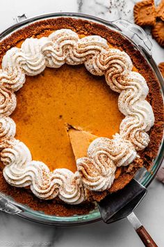 a pumpkin pie with whipped cream on top