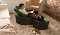 a man sitting in a chair reading a book