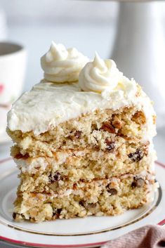 a piece of cake with white frosting on a plate