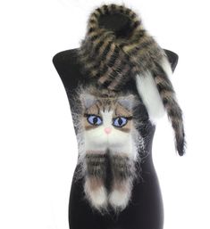 a mannequin head with a cat on it's back and blue eyes