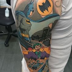 a man with a batman tattoo on his arm