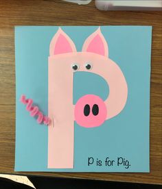 a pink pig on a blue background with the letter p is for pig