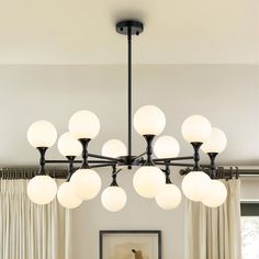 a modern chandelier hangs over a dining room table