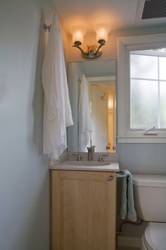 a bathroom with white towels hanging on the wall